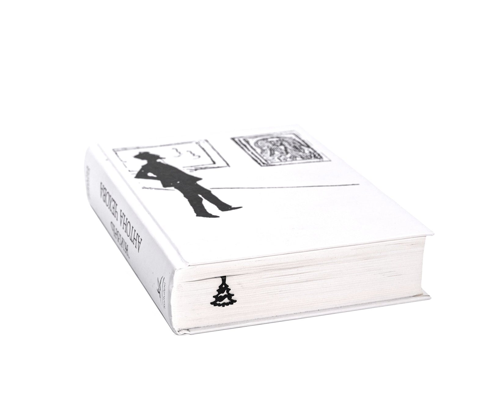 Winter Sleigh Ride metal bookmark in a closed book, only its top showing above the pages