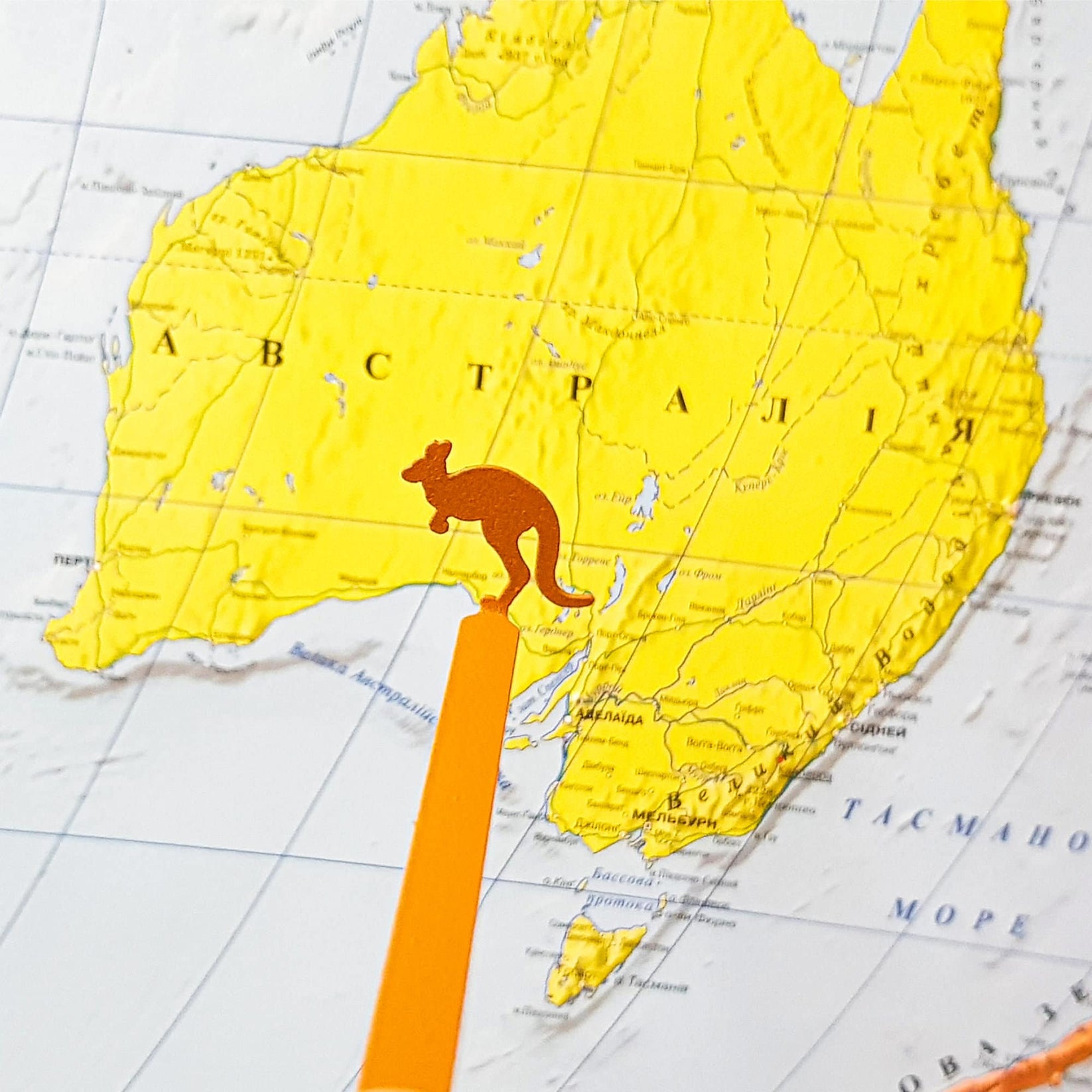 Kangaroo metal bookmark in gold against a coloured backdrop