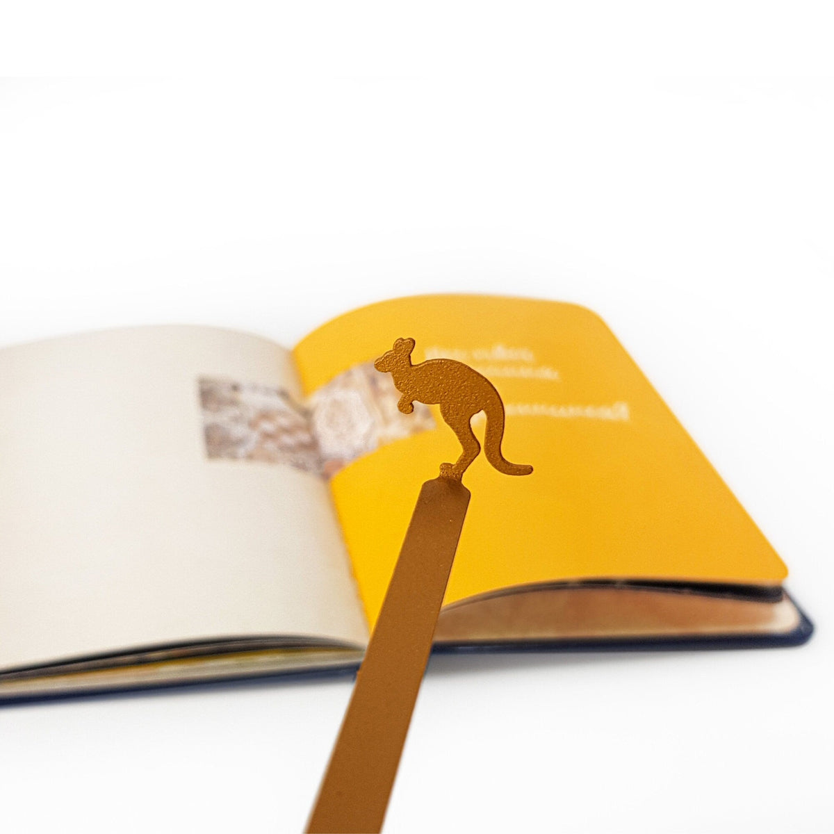Kangaroo metal bookmark in gold marking a page in an open book