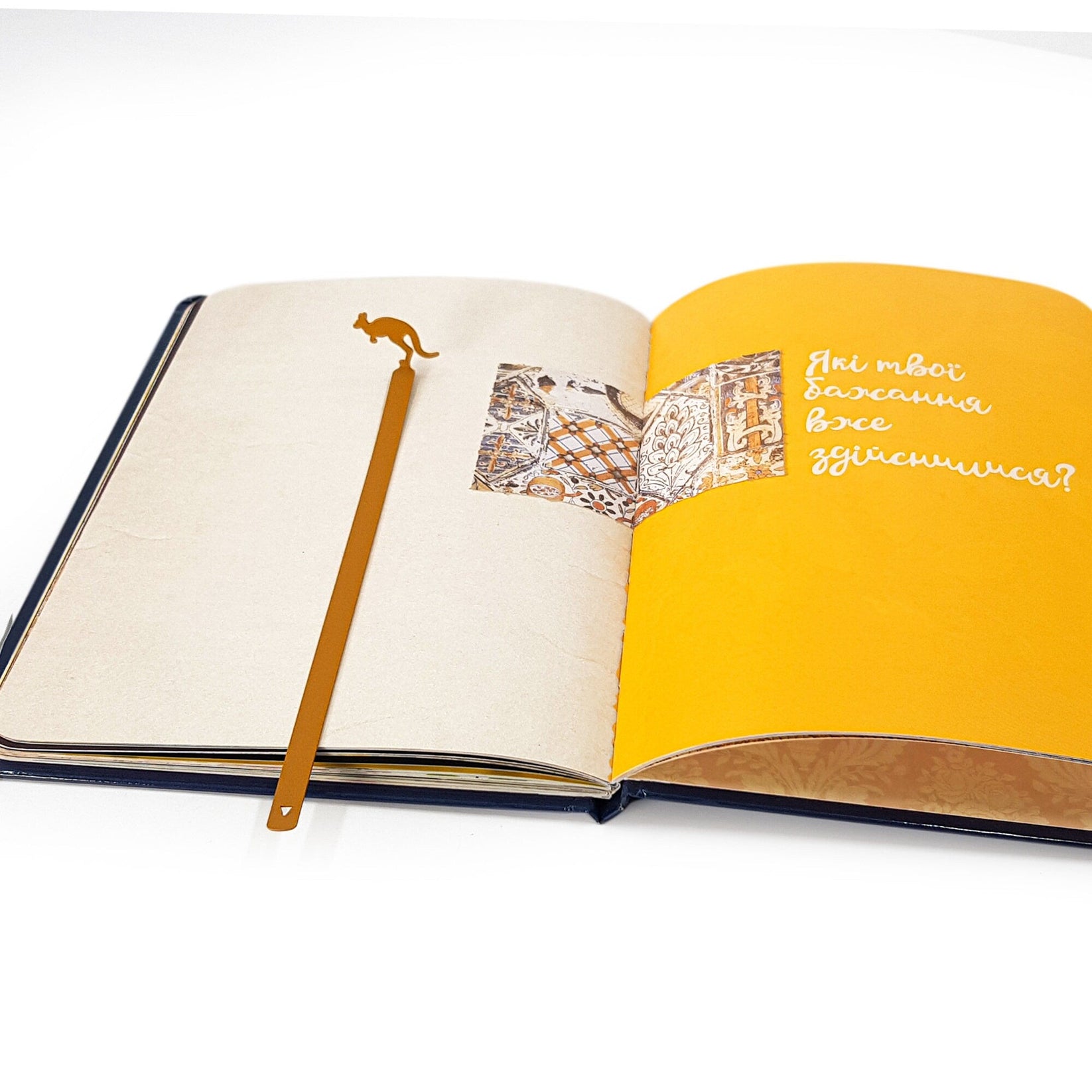 Kangaroo metal bookmark in gold lying across the pages of an open book