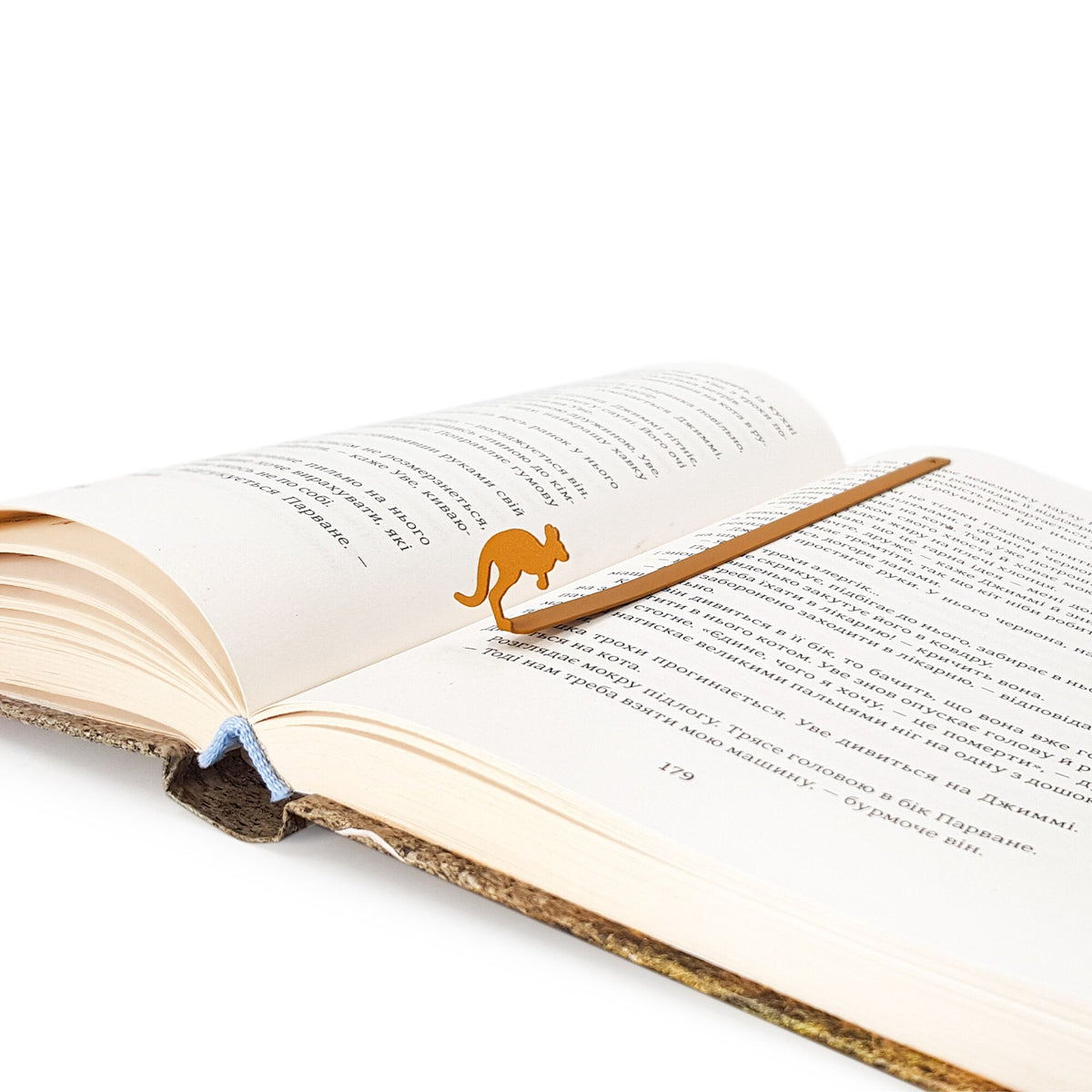 Kangaroo metal bookmark in gold resting on the pages of an open book, view 5