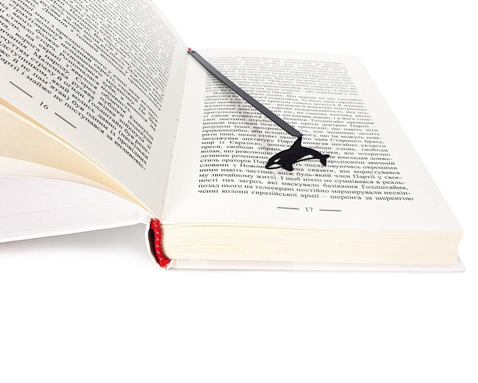 Killer Whale Orca metal bookmark set into the gutter of an open book