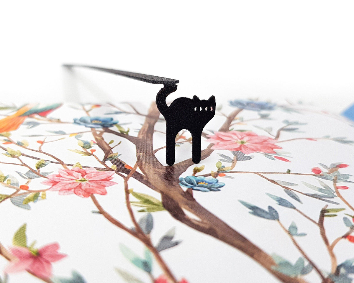 Kitty Grace metal bookmark on an illustrated page