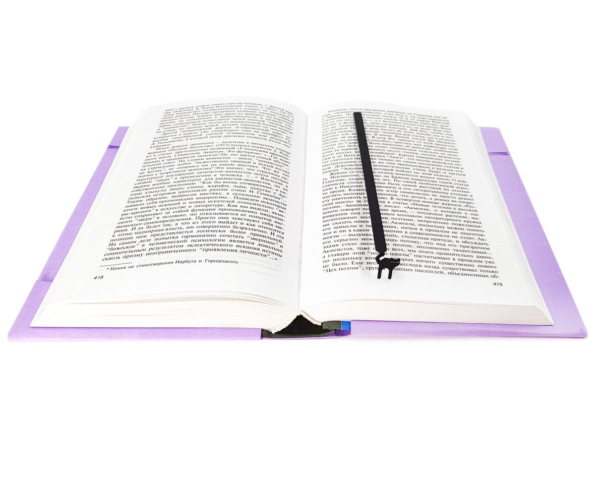 Kitty Grace metal bookmark resting on the pages of an open book