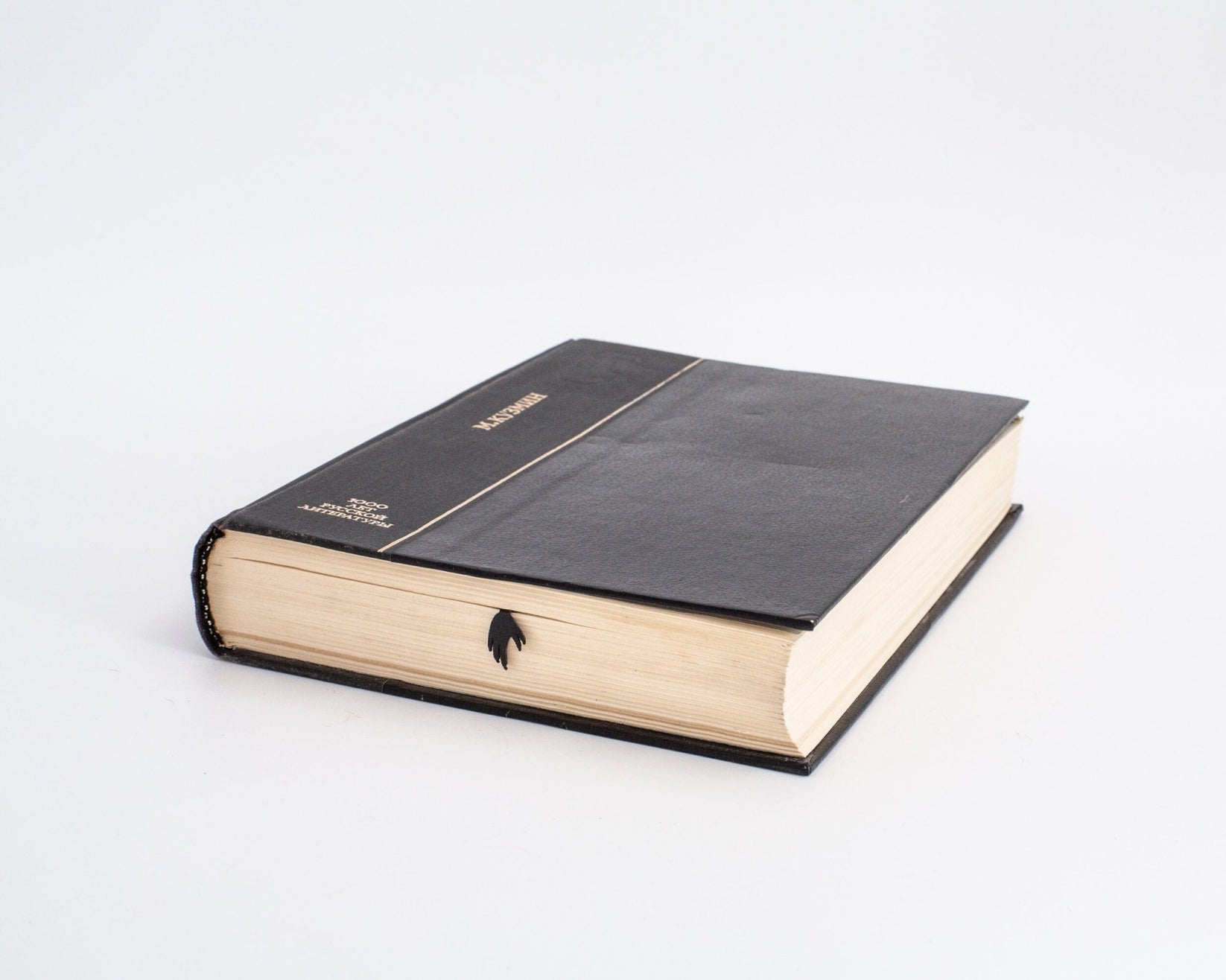 Koala metal bookmark in a closed book, only its top showing above the pages