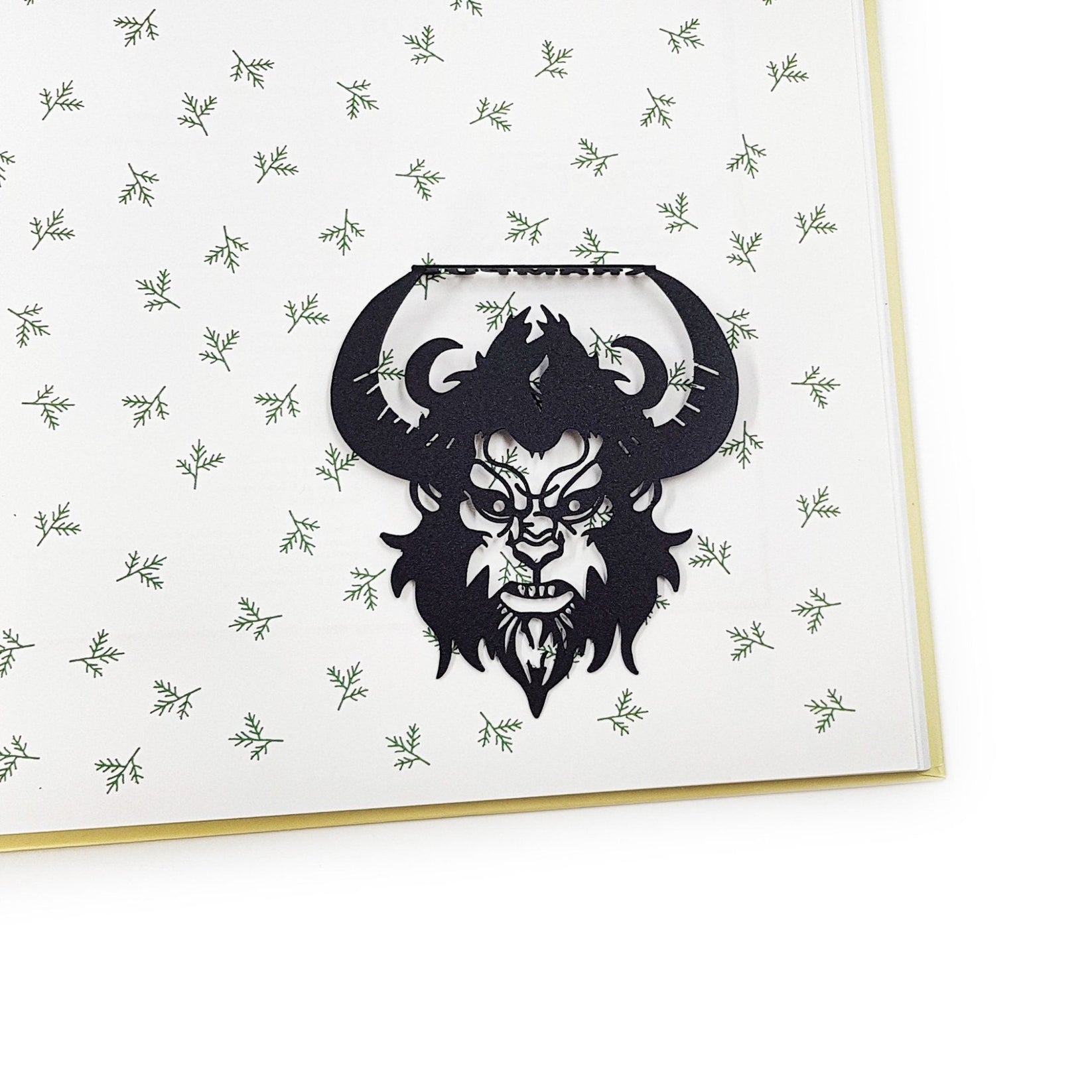 Krampus metal bookmark on a coloured background