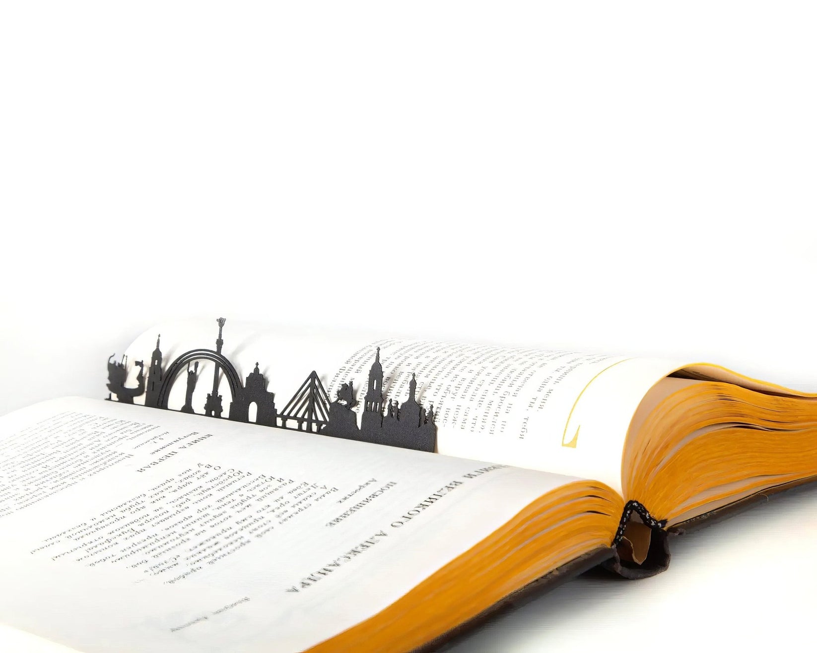 Kyiv Cityscape metal bookmark resting on the pages of an open book