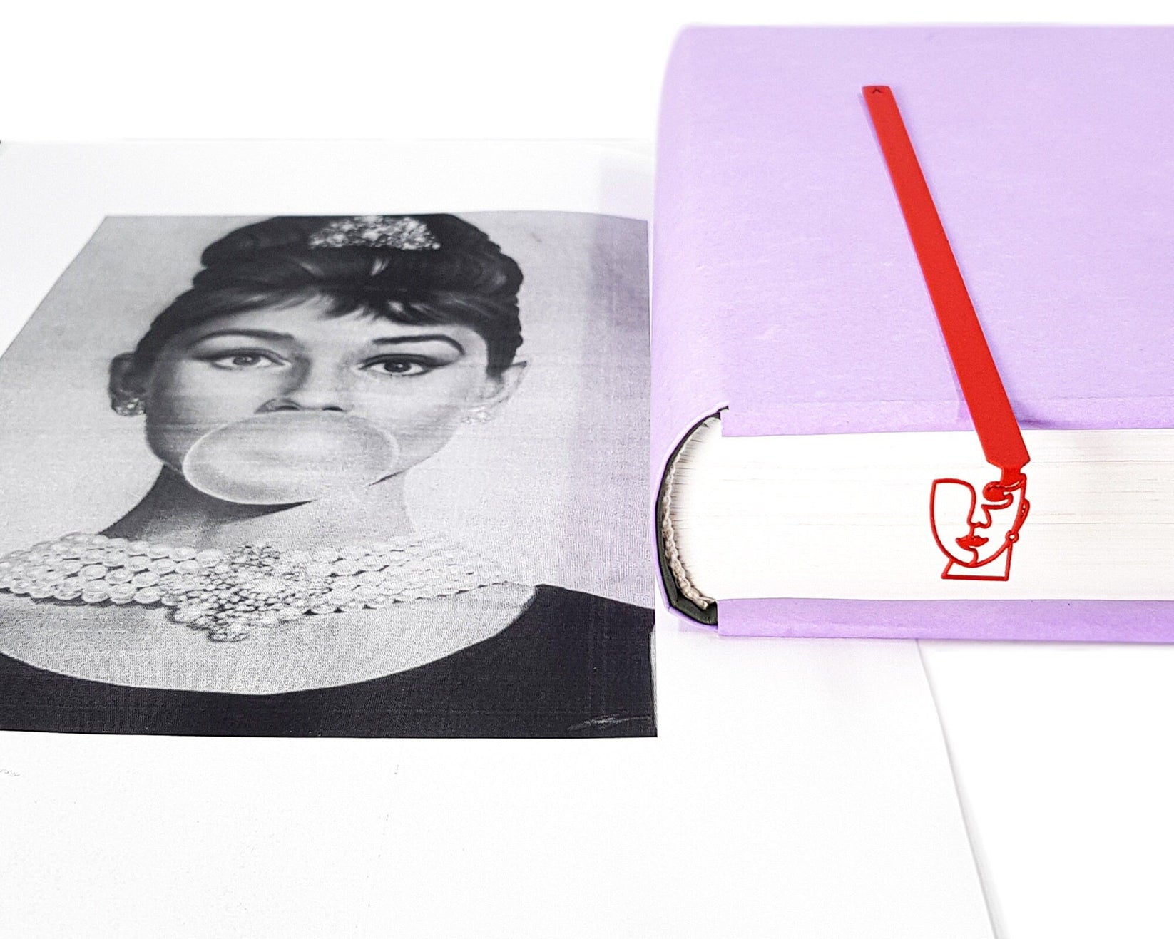 Lady in Red metal bookmark in red placed on a colour illustration