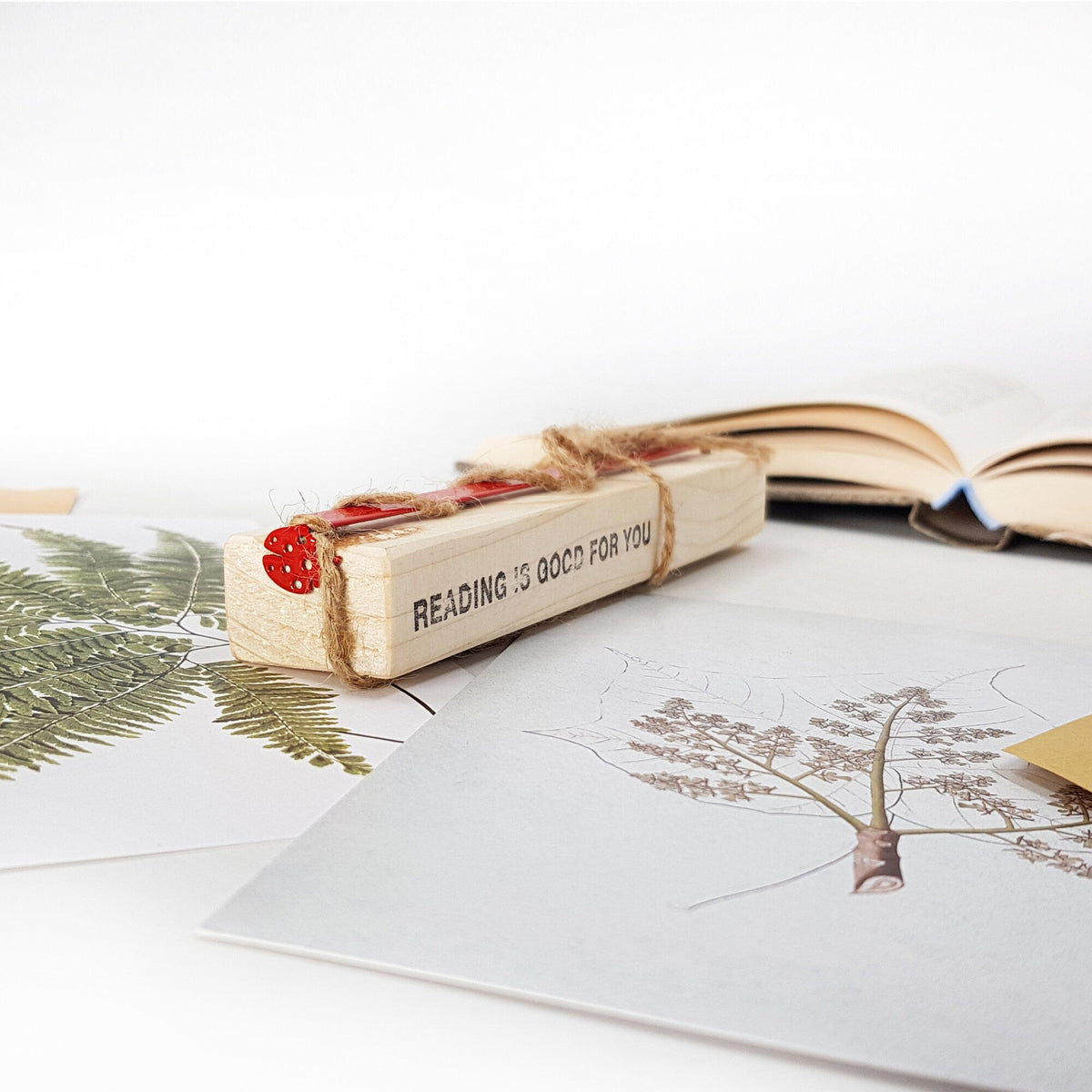 Ladybird metal bookmark in red with the engraved wooden gift block it ships with