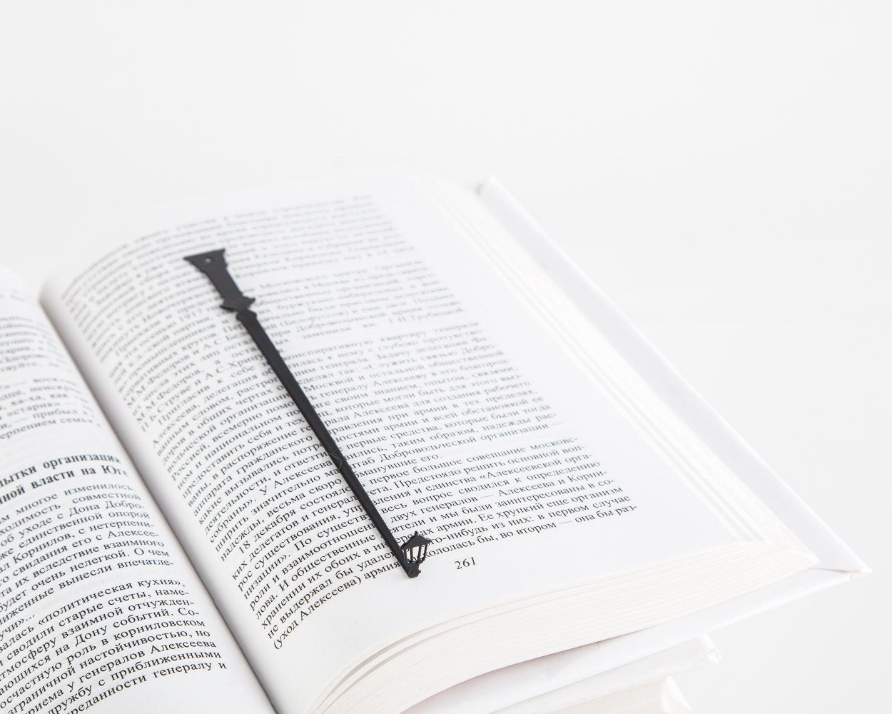 Lamppost metal bookmark resting on the pages of an open book