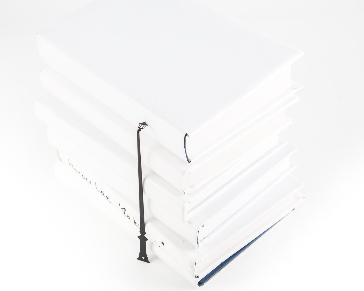 Lamppost metal bookmark shown with a stack of books