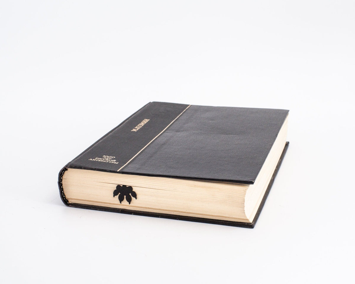 Lion Head metal bookmark in a closed book, only its top showing above the pages