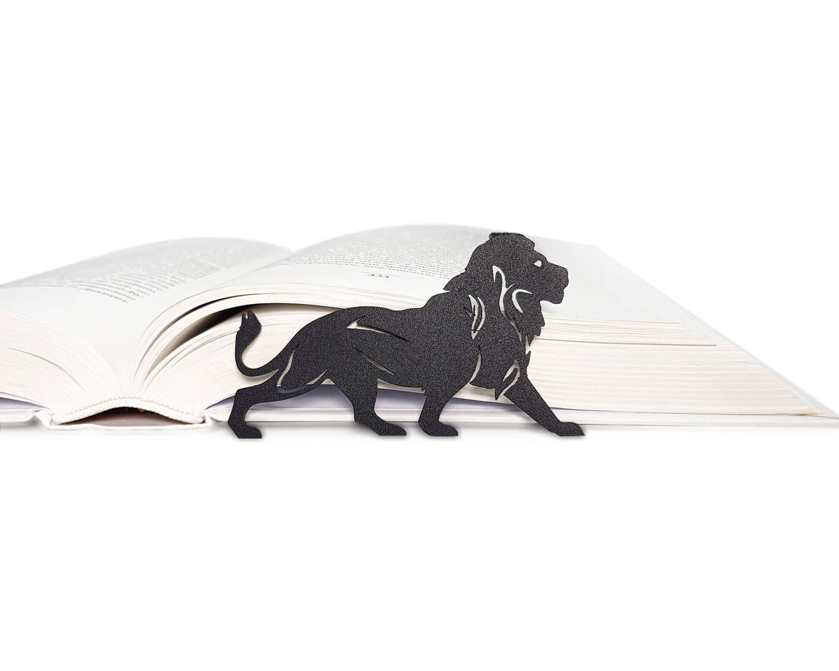 Lion, The King of Animals metal bookmark lying across the pages of an open book