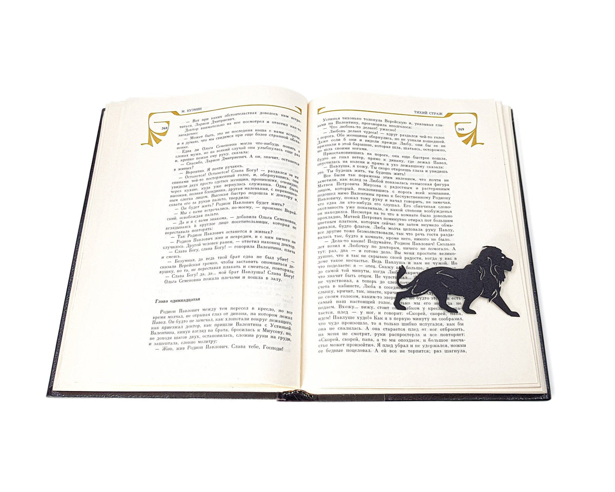Lion, The King of Animals metal bookmark set into the gutter of an open book