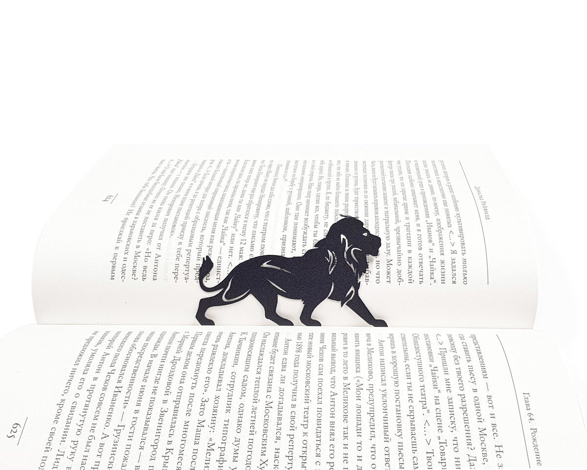 Lion, The King of Animals metal bookmark resting on the pages of an open book