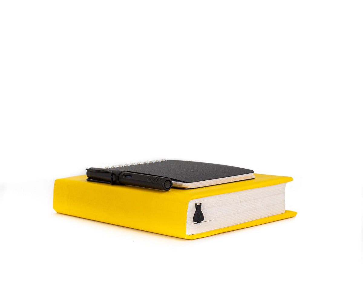 Little Black Dress metal bookmark on a coloured background