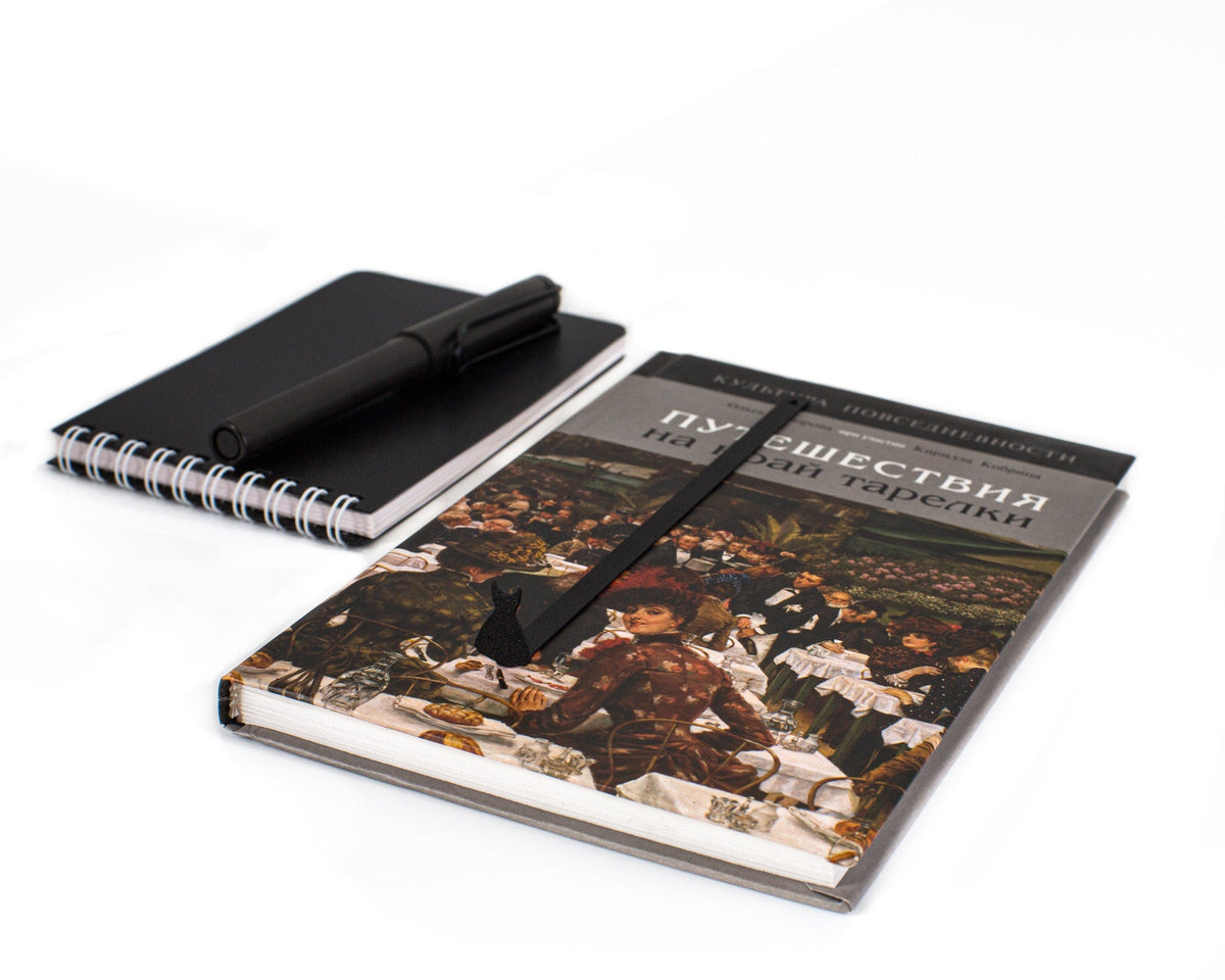 Little Black Dress metal bookmark marking a page in a notebook