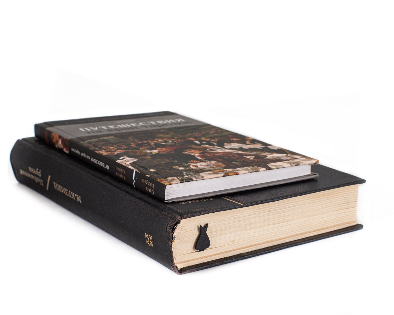Little Black Dress metal bookmark in a closed book, only its top showing above the pages