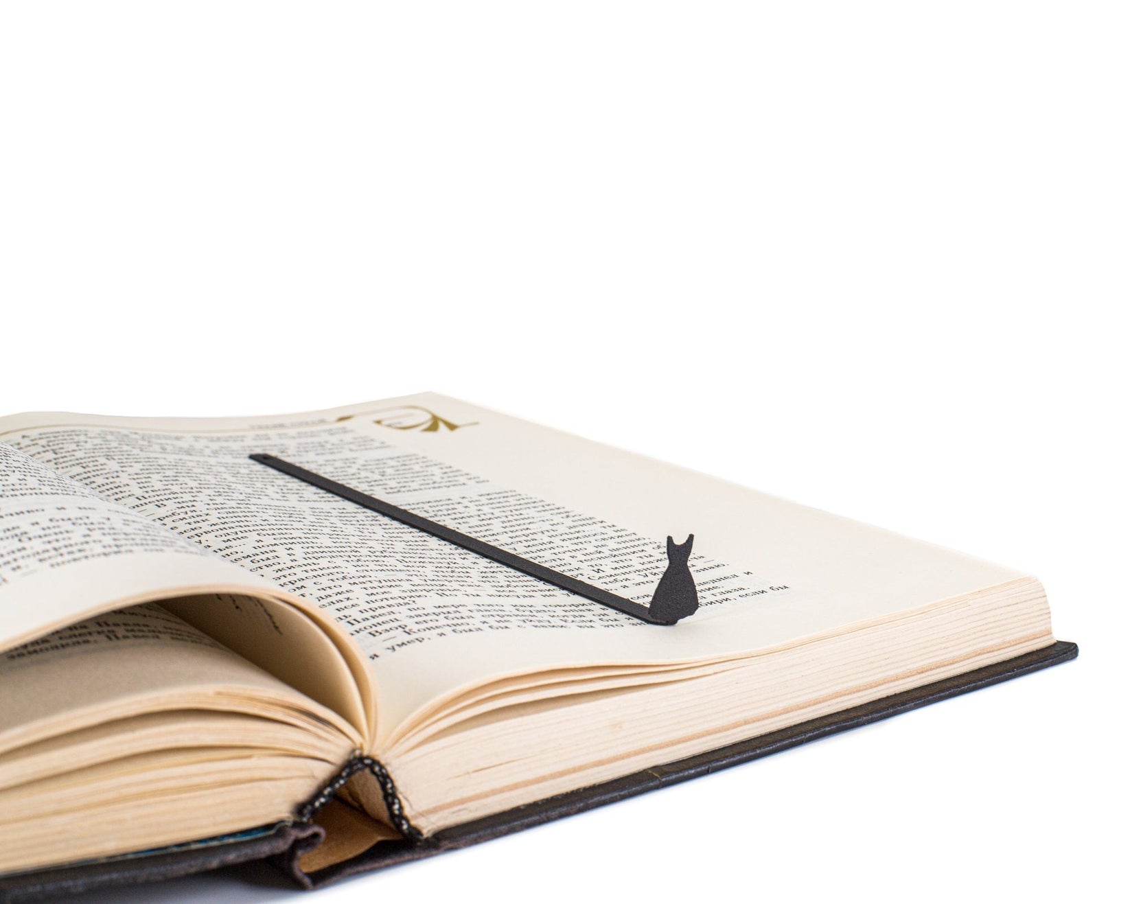 Little Black Dress metal bookmark resting on the pages of an open book