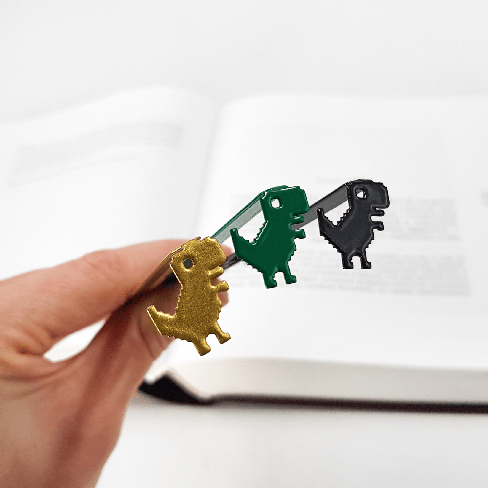 Little Dino metal bookmark shown together with other bookmarks from the range