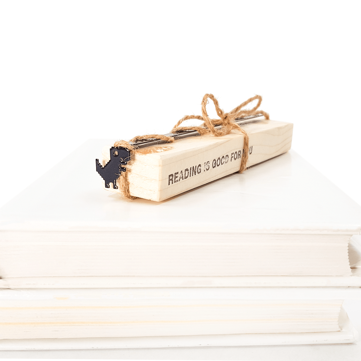 Little Dino metal bookmark with the engraved wooden gift block it ships with