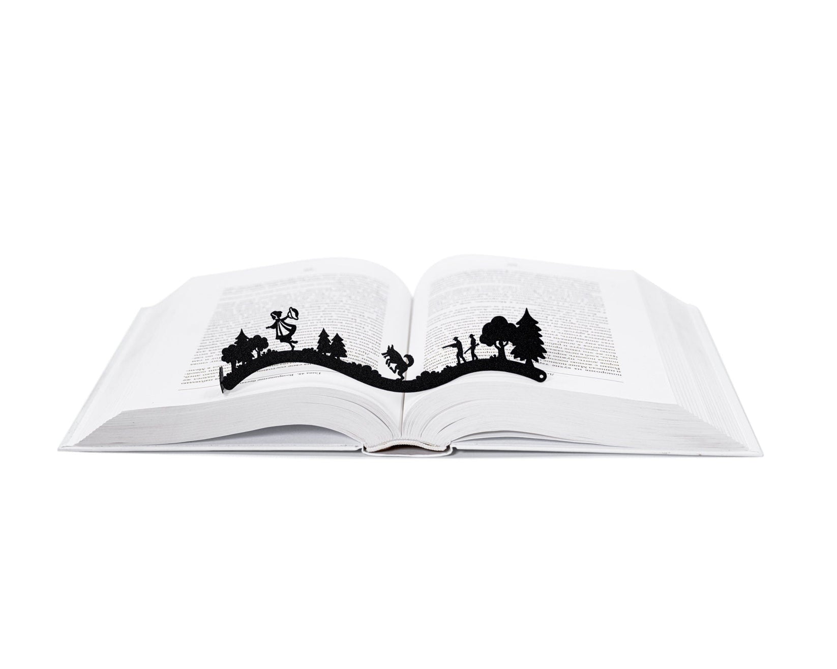 Little Red Riding Hood metal bookmark marking a page in an open book