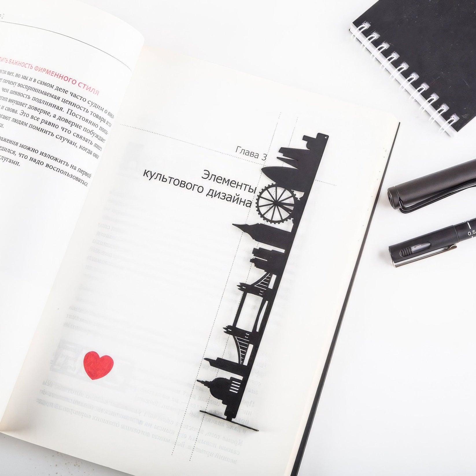 London metal bookmark lying across the pages of an open book
