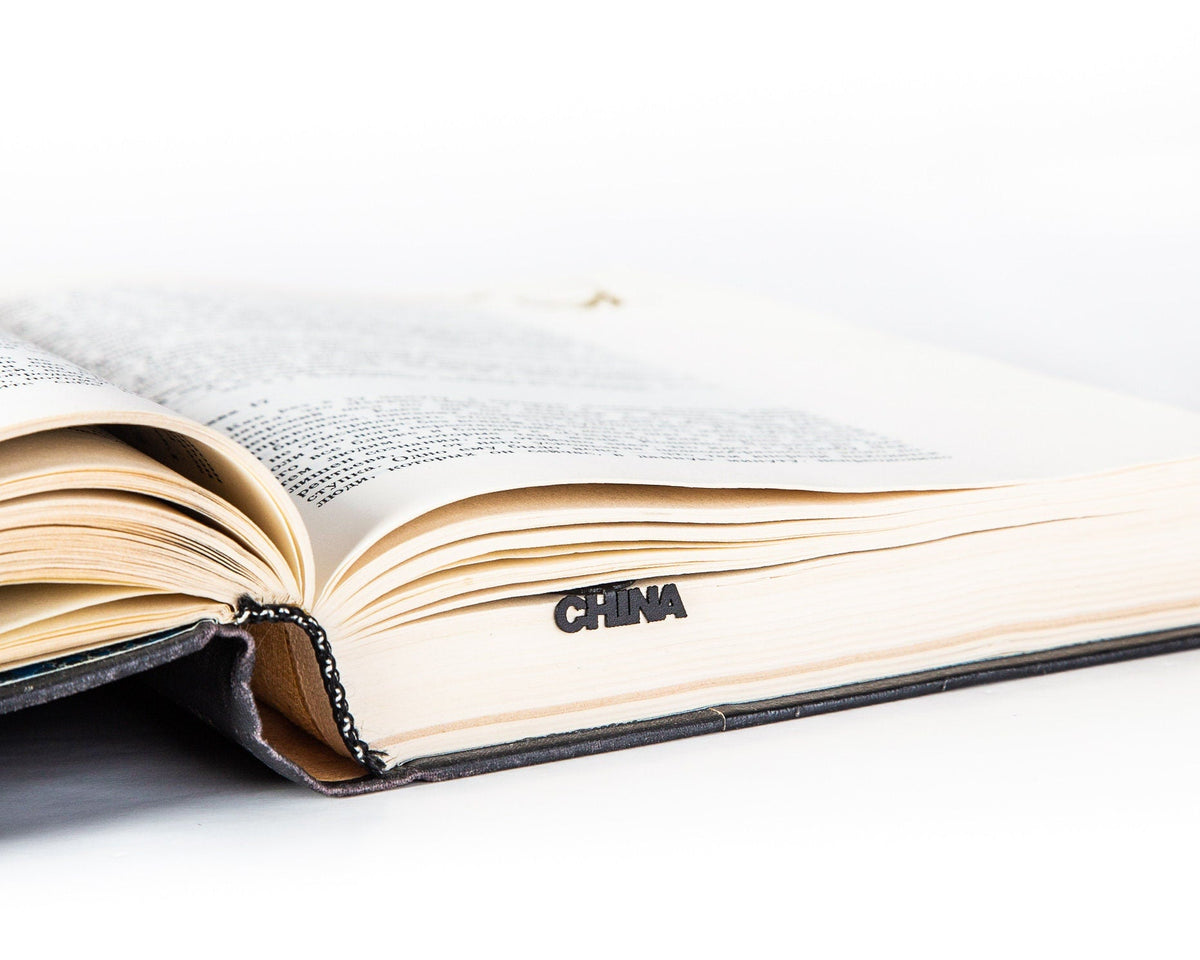 Map of China metal bookmark lying across the pages of an open book
