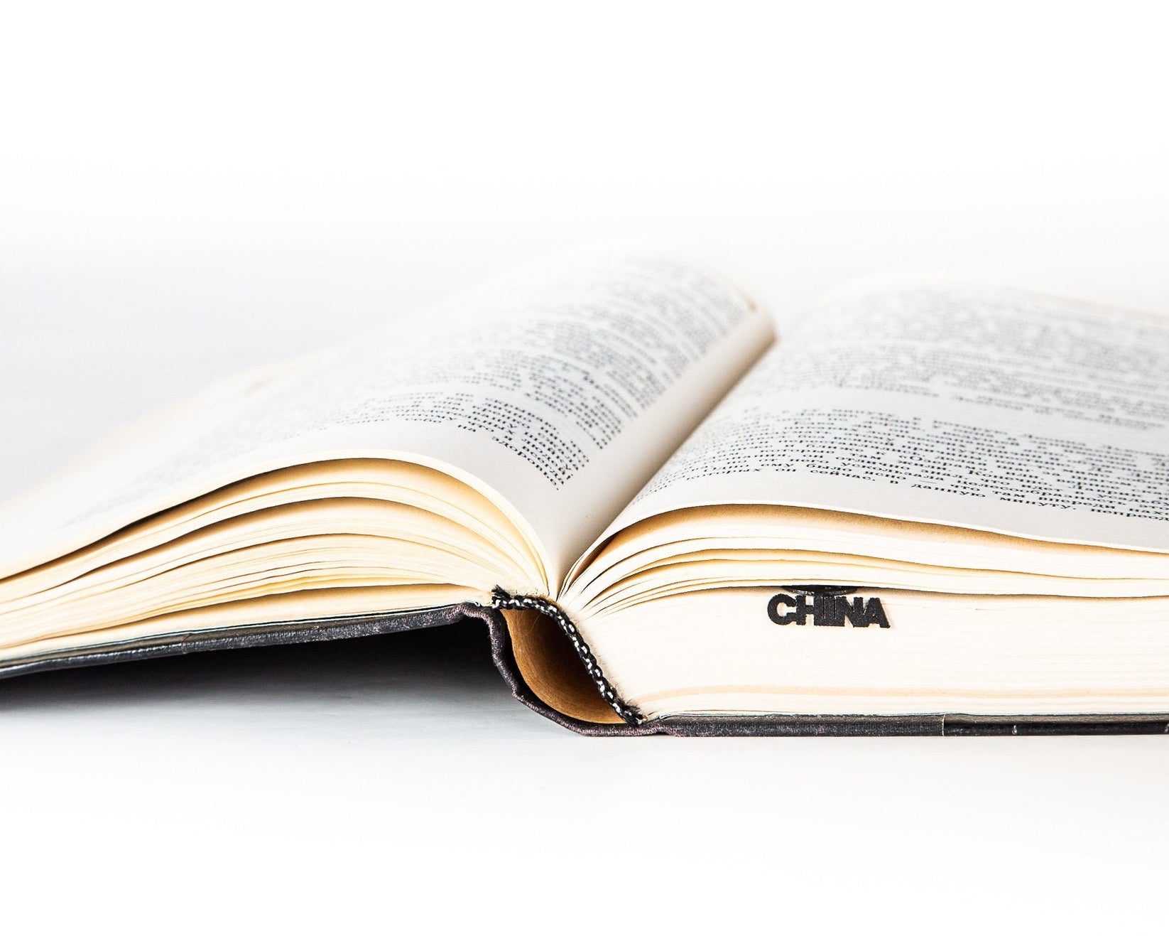 Map of China metal bookmark resting on the pages of an open book