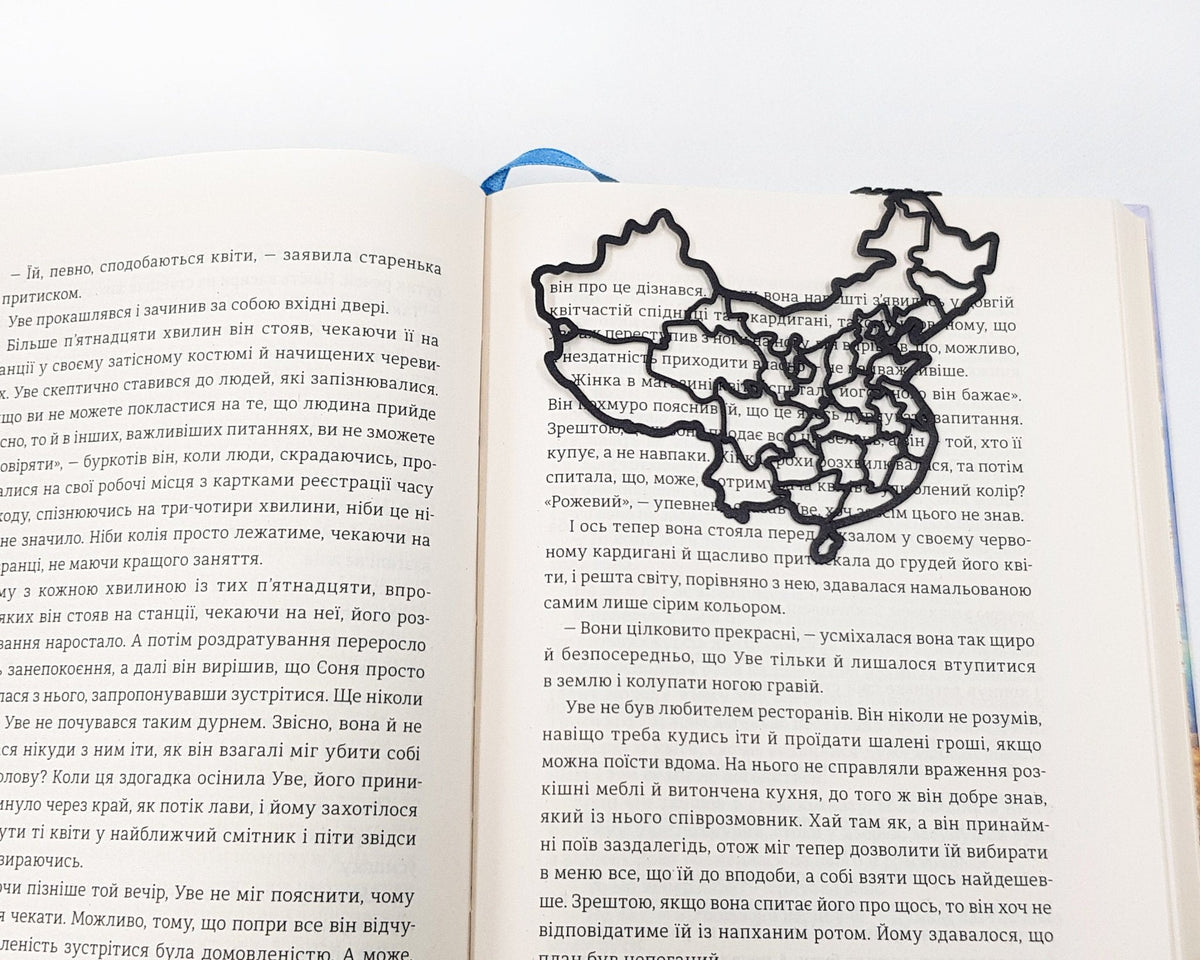 Map of China metal bookmark set into the gutter of an open book