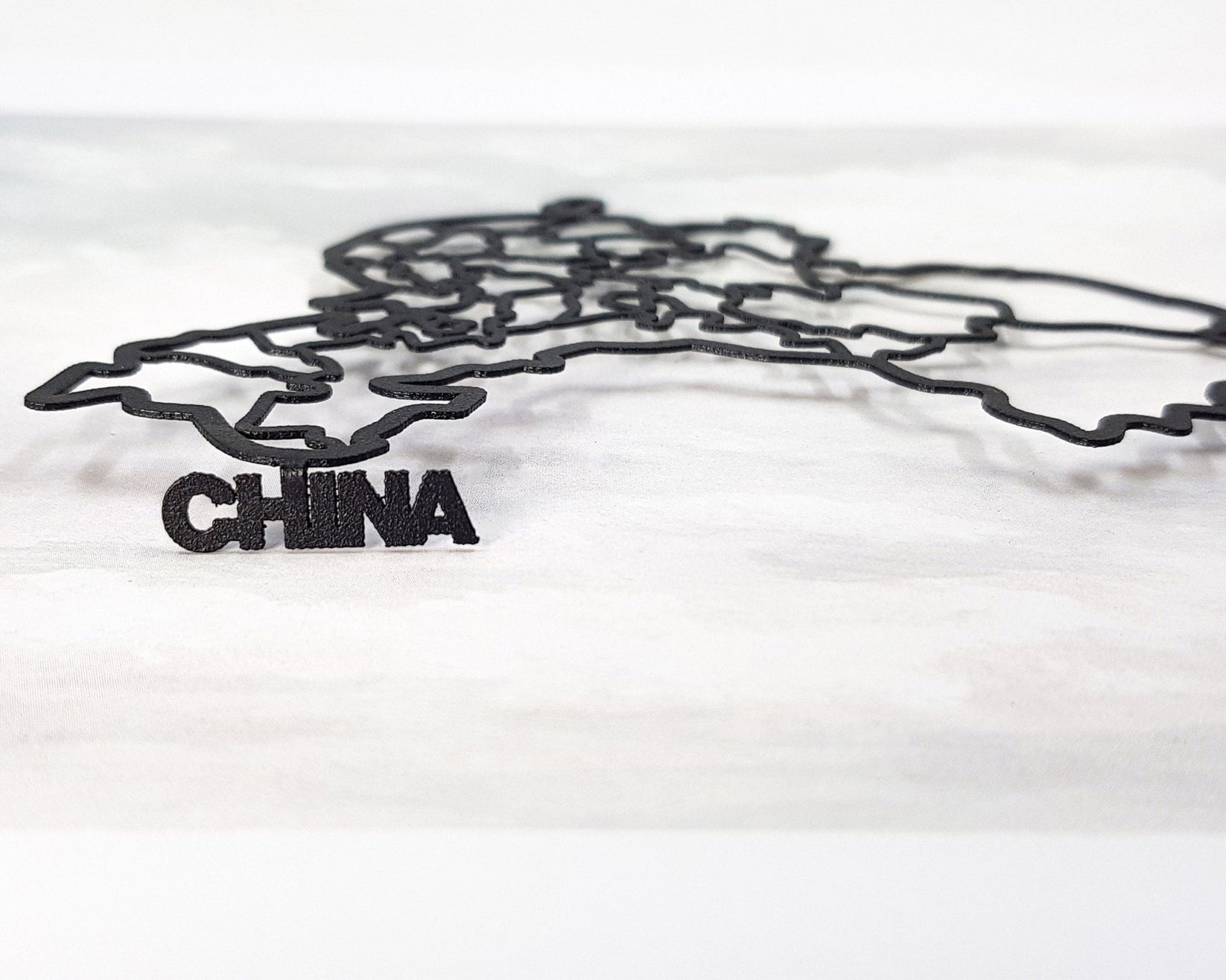 Map of China metal bookmark against a coloured backdrop