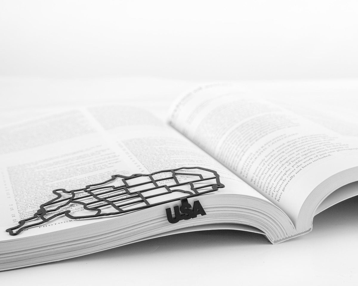 Map of USA metal bookmark marking a page in an open book