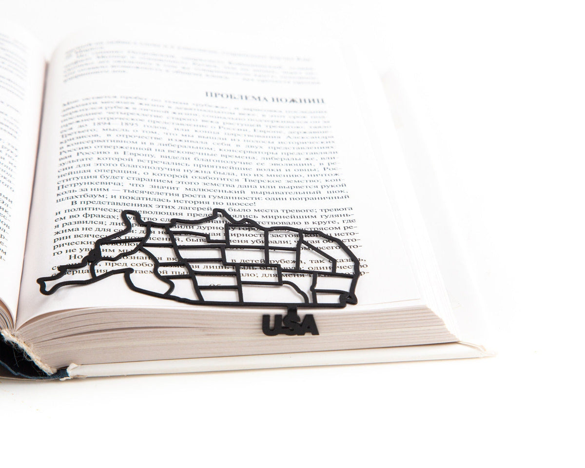 Map of USA metal bookmark set into the gutter of an open book