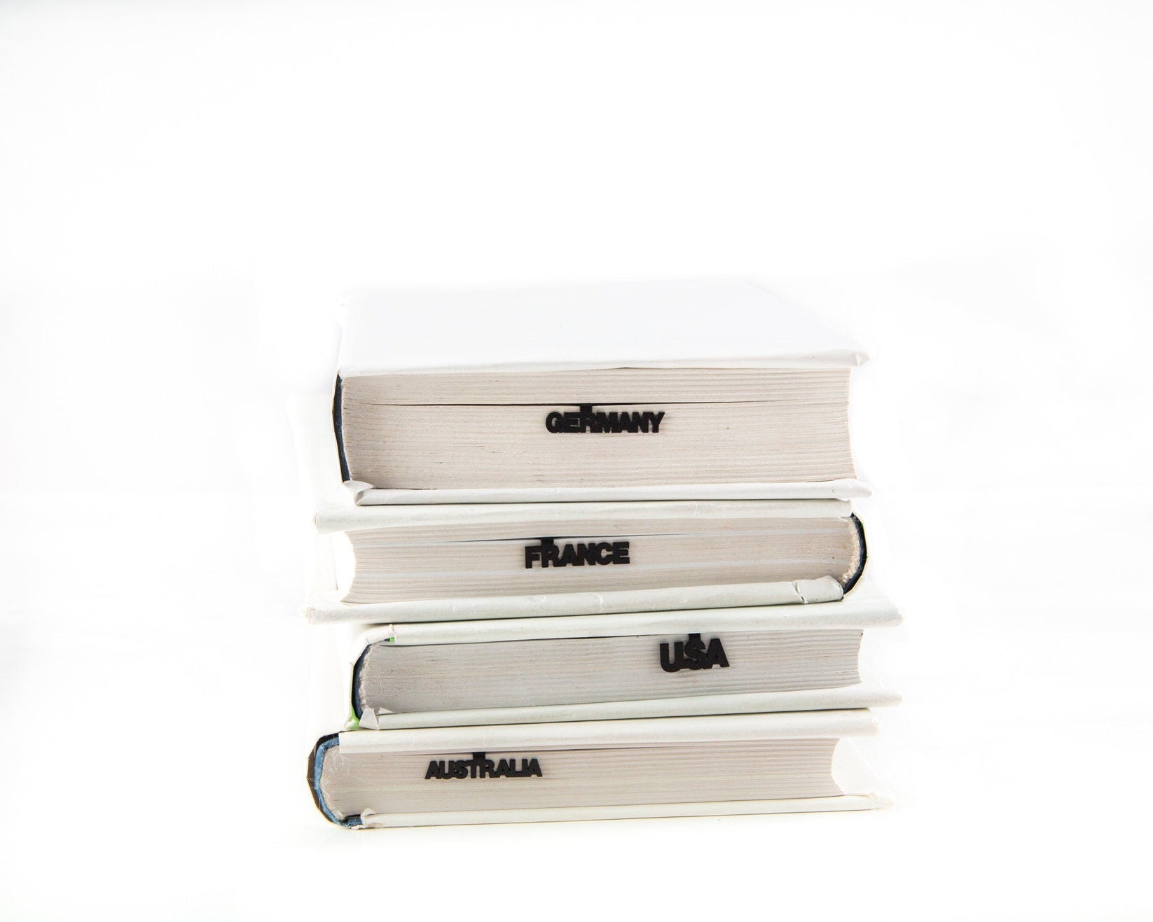 Map of USA metal bookmark shown with a stack of books