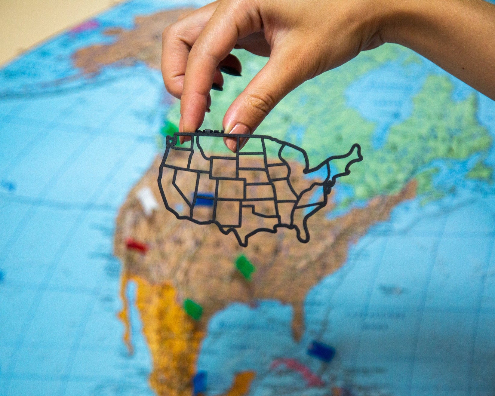 Map of USA metal bookmark on a coloured background