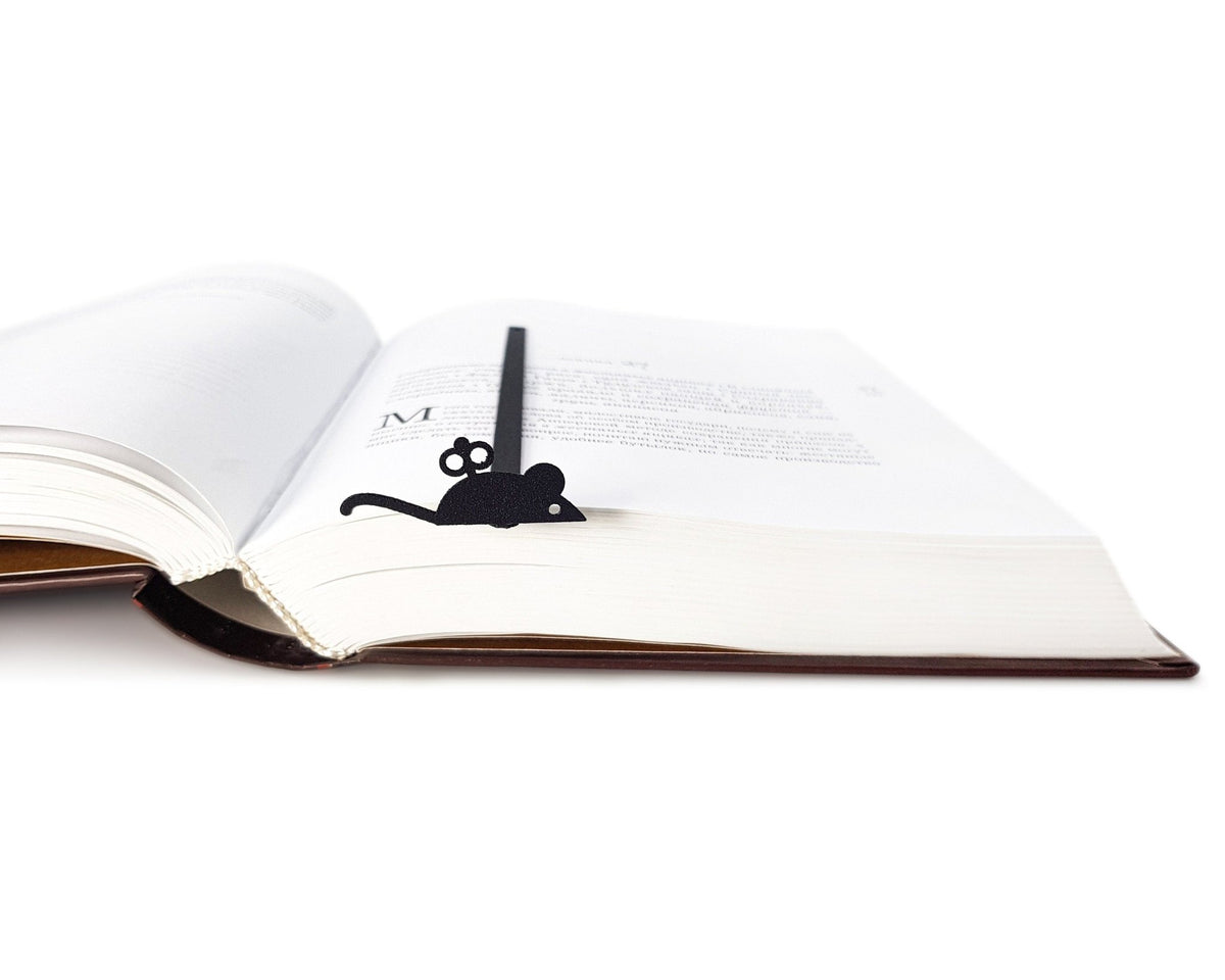 Mechanical Mouse metal bookmark resting on the pages of an open book, view 5