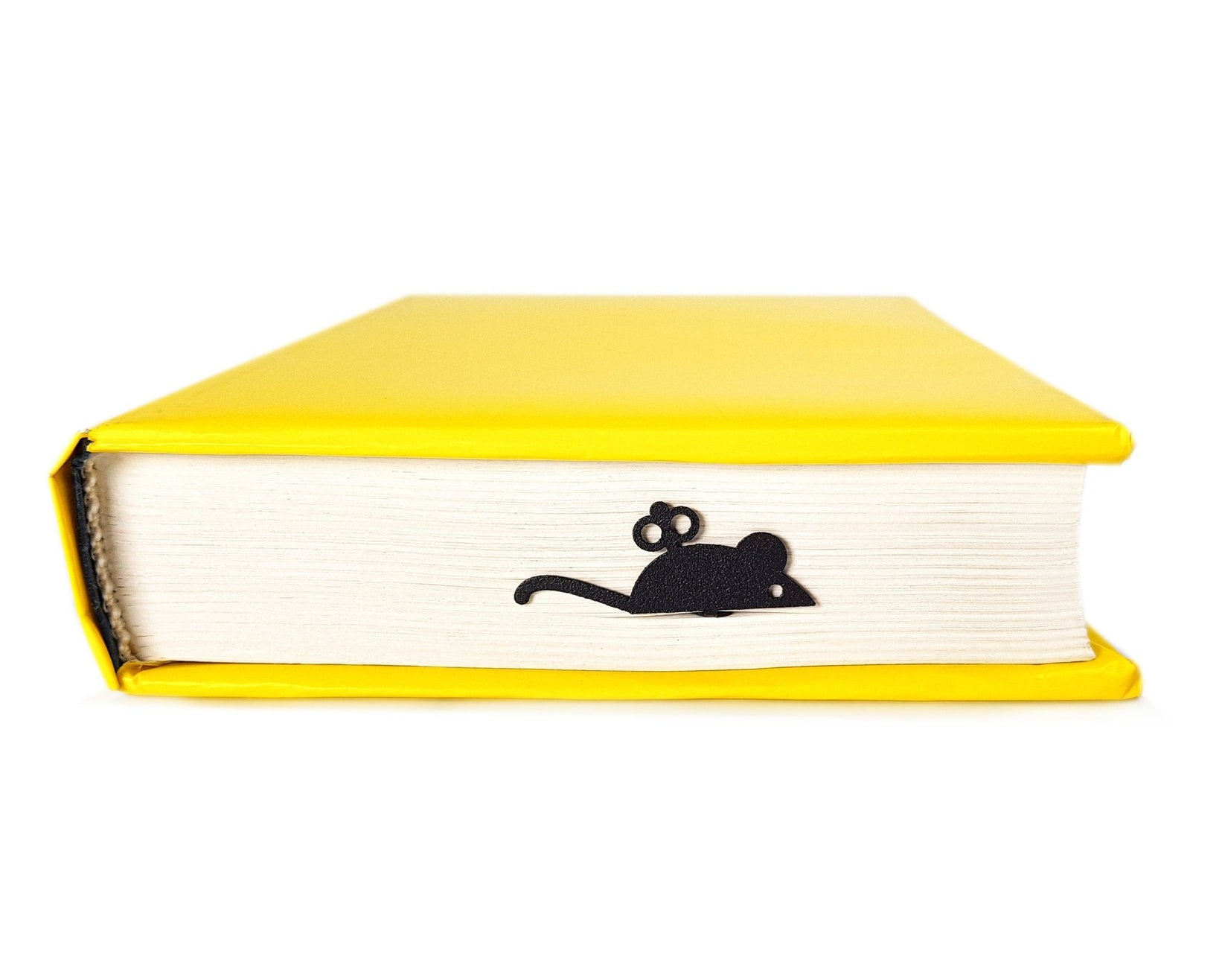 Mechanical Mouse metal bookmark in a closed book, only its top showing above the pages
