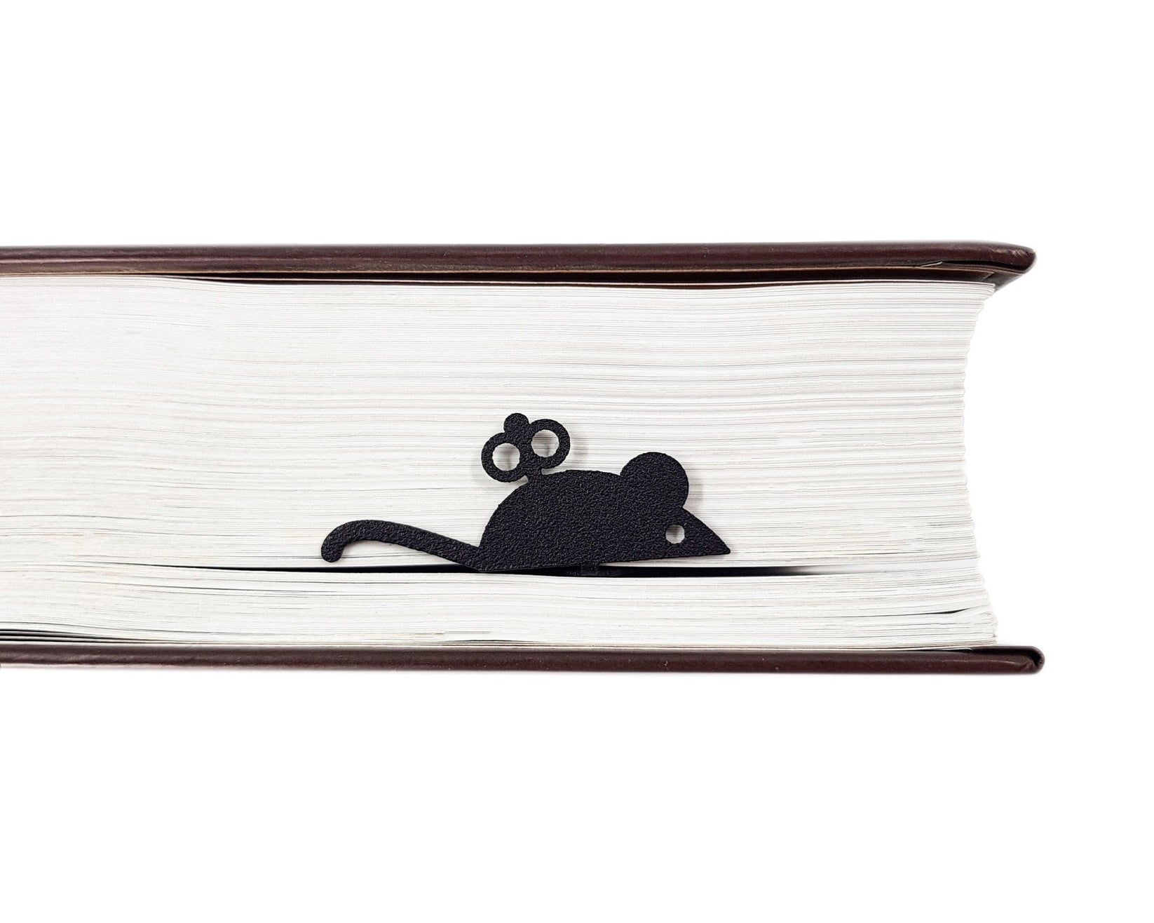 Mechanical Mouse metal bookmark resting on the pages of an open book