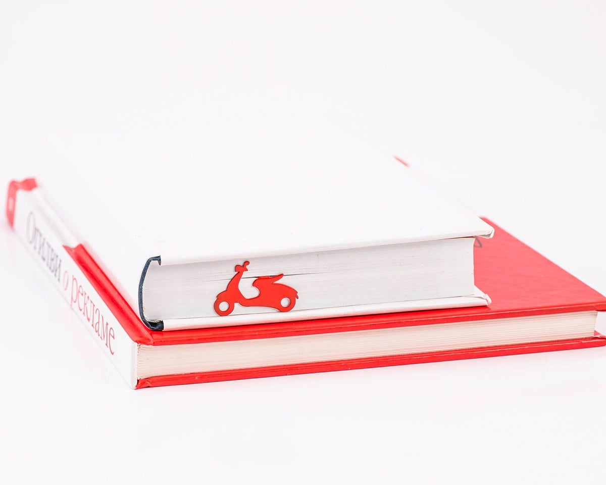 Motor Scooter metal bookmark in red in a closed book, only its top showing above the pages