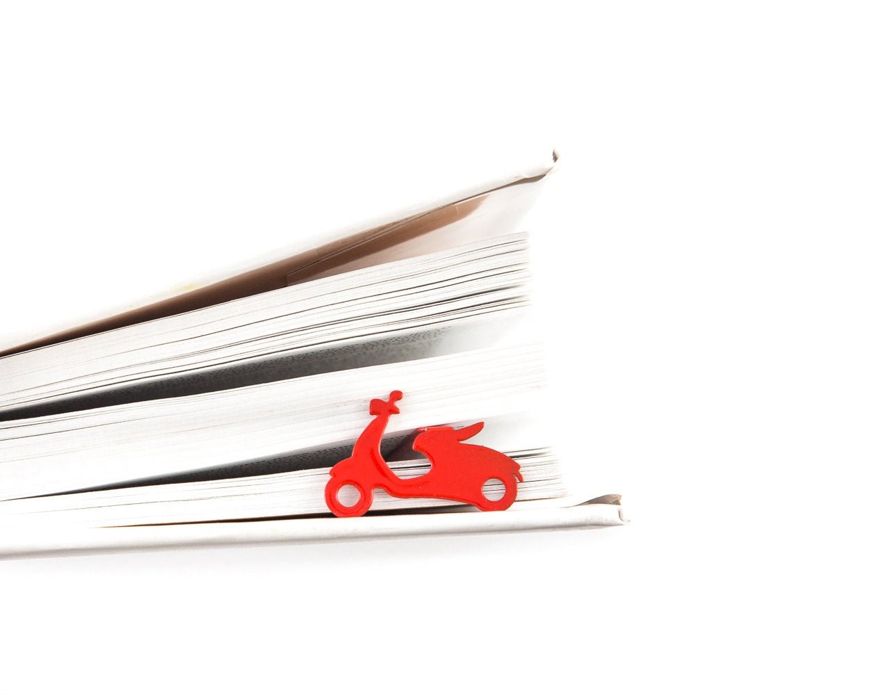 Motor Scooter metal bookmark in red resting on the pages of an open book