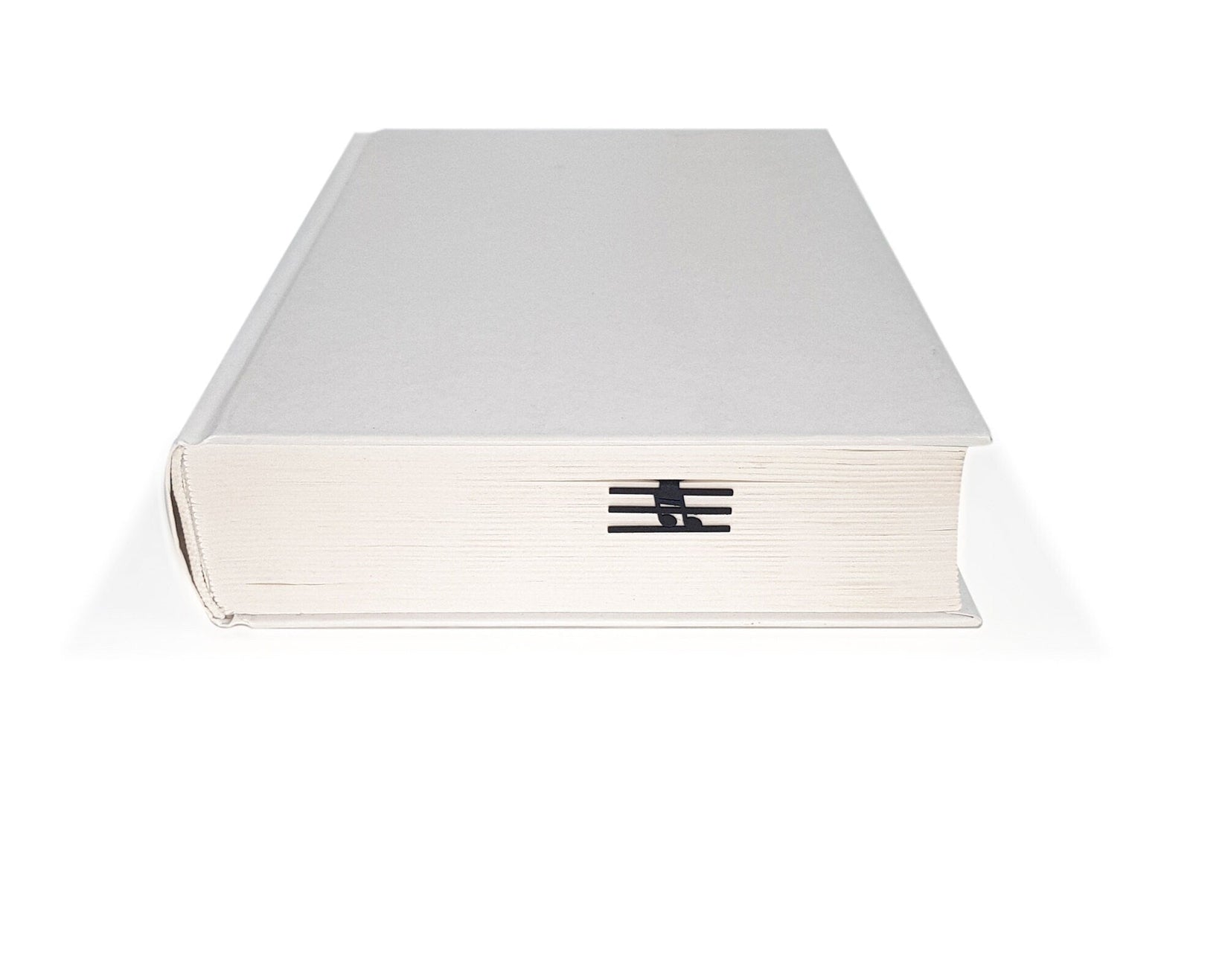 Musical Note metal bookmark in a closed book, only its top showing above the pages