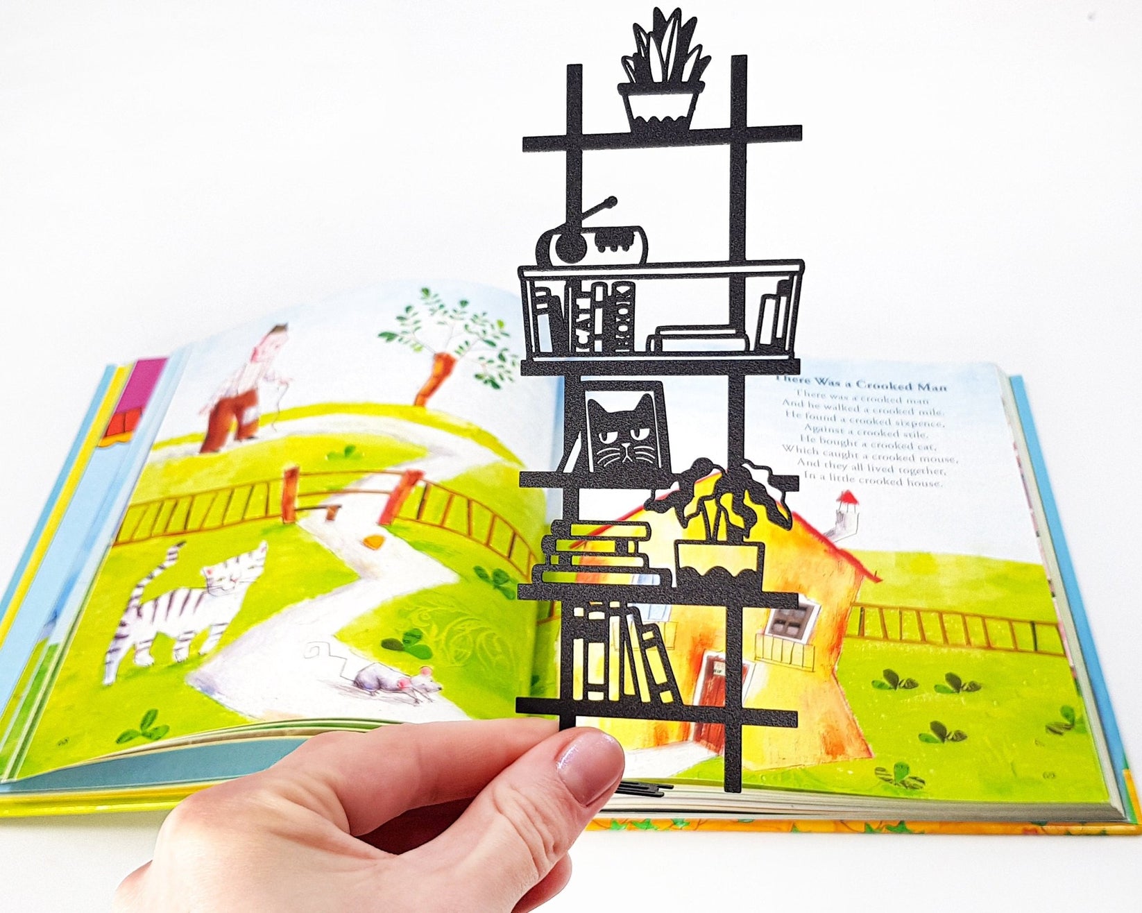 My Bookshelf metal bookmark marking a page in an illustrated book