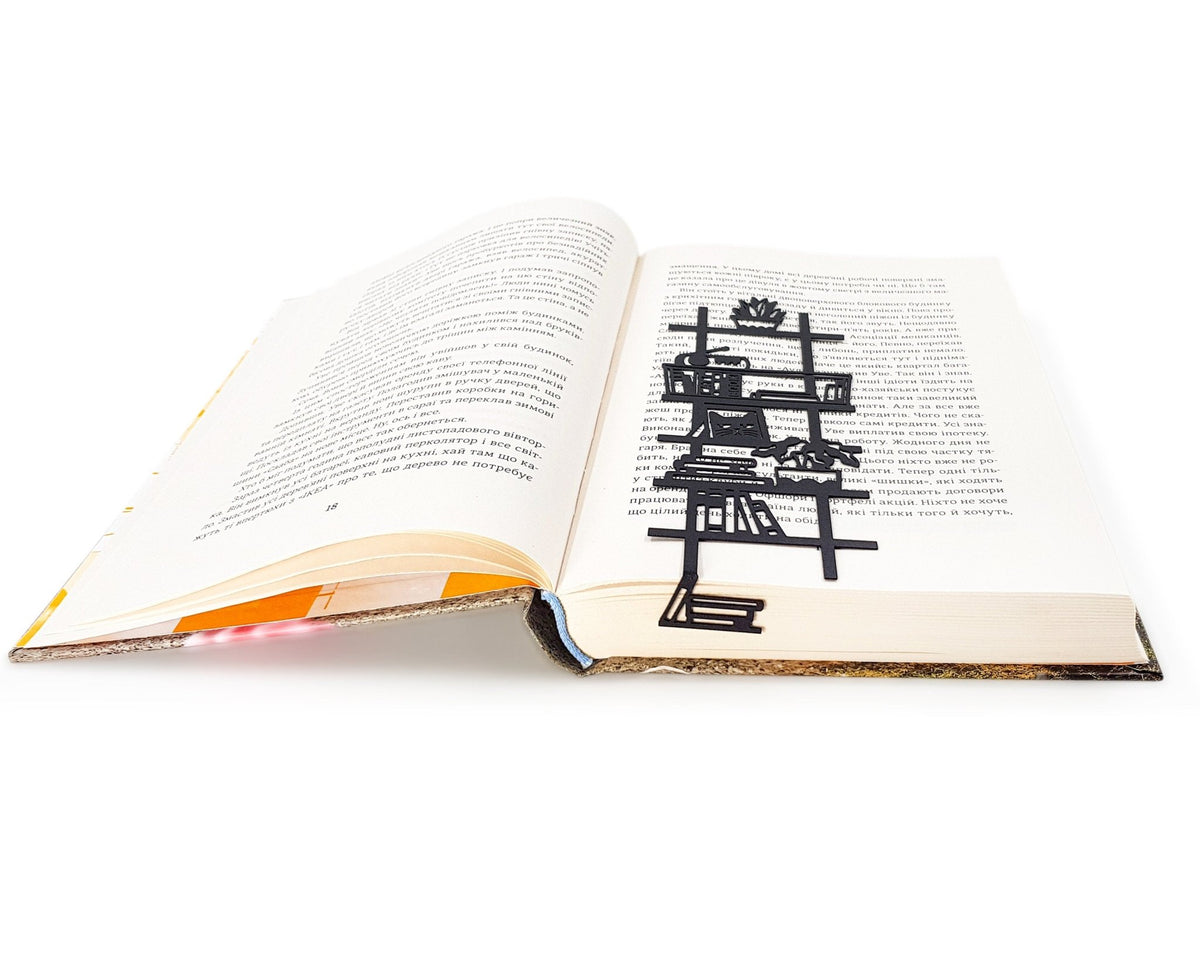 My Bookshelf metal bookmark resting on the pages of an open book