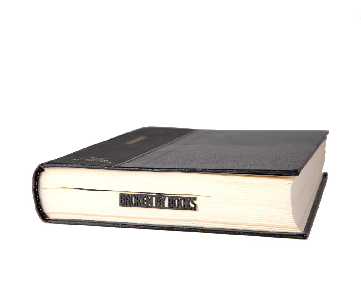 My Heart Is Broken by Books metal bookmark in a closed book, only its top showing above the pages