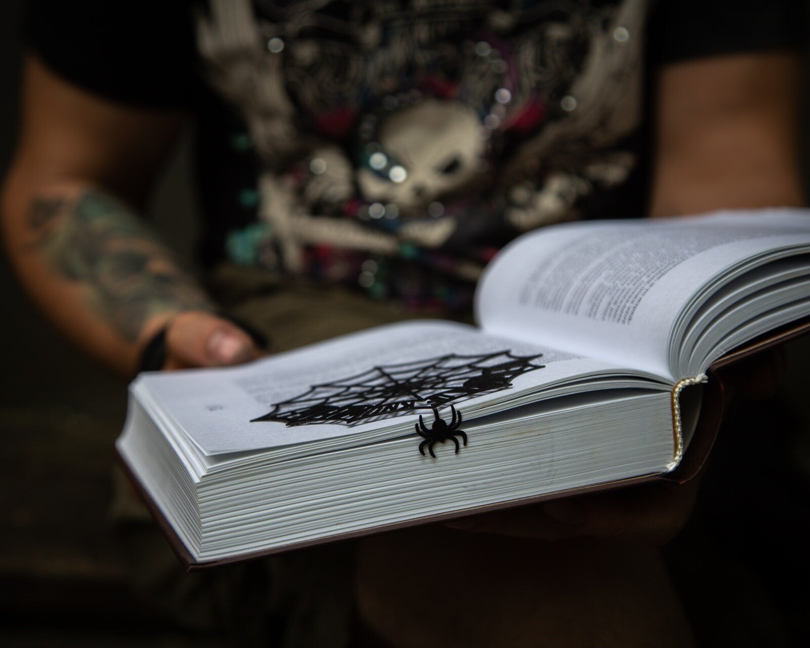 Network of Knowledge metal bookmark held in a hand to show its size