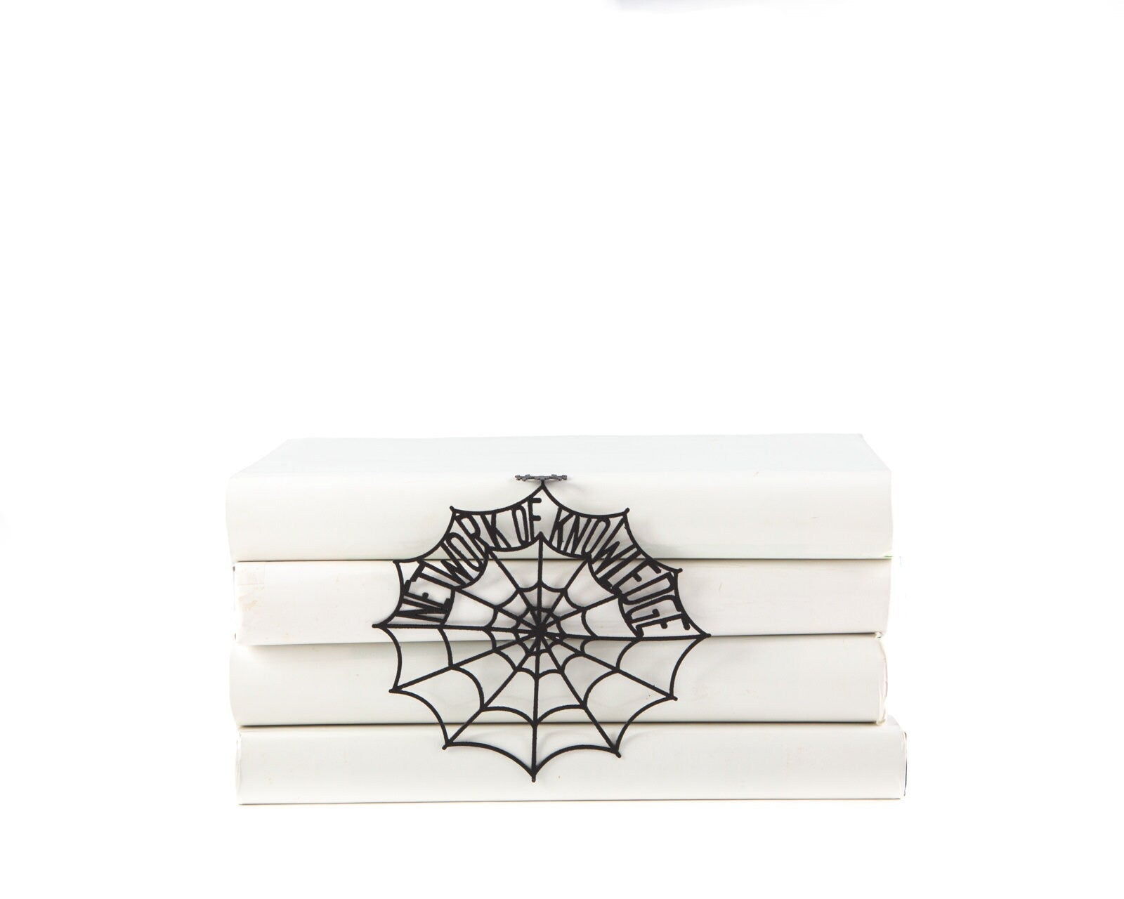 Network of Knowledge metal bookmark shown with a stack of books