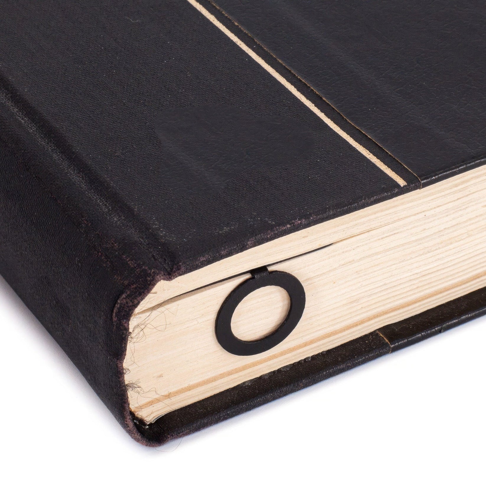 Numbers Bauhaus Style metal bookmark in a closed book, only its top showing above the pages