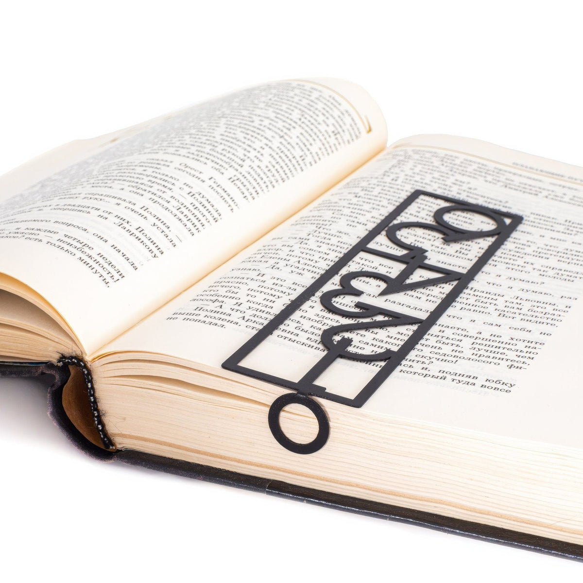Numbers Bauhaus Style metal bookmark resting on the pages of an open book, view 5