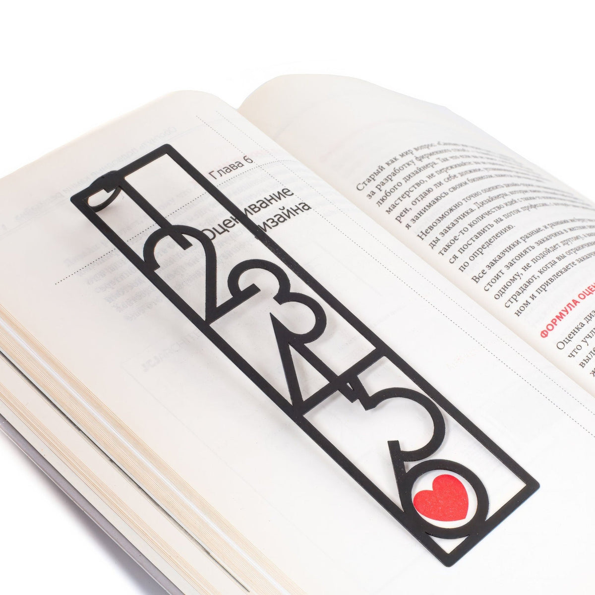 Numbers Bauhaus Style metal bookmark set into the gutter of an open book