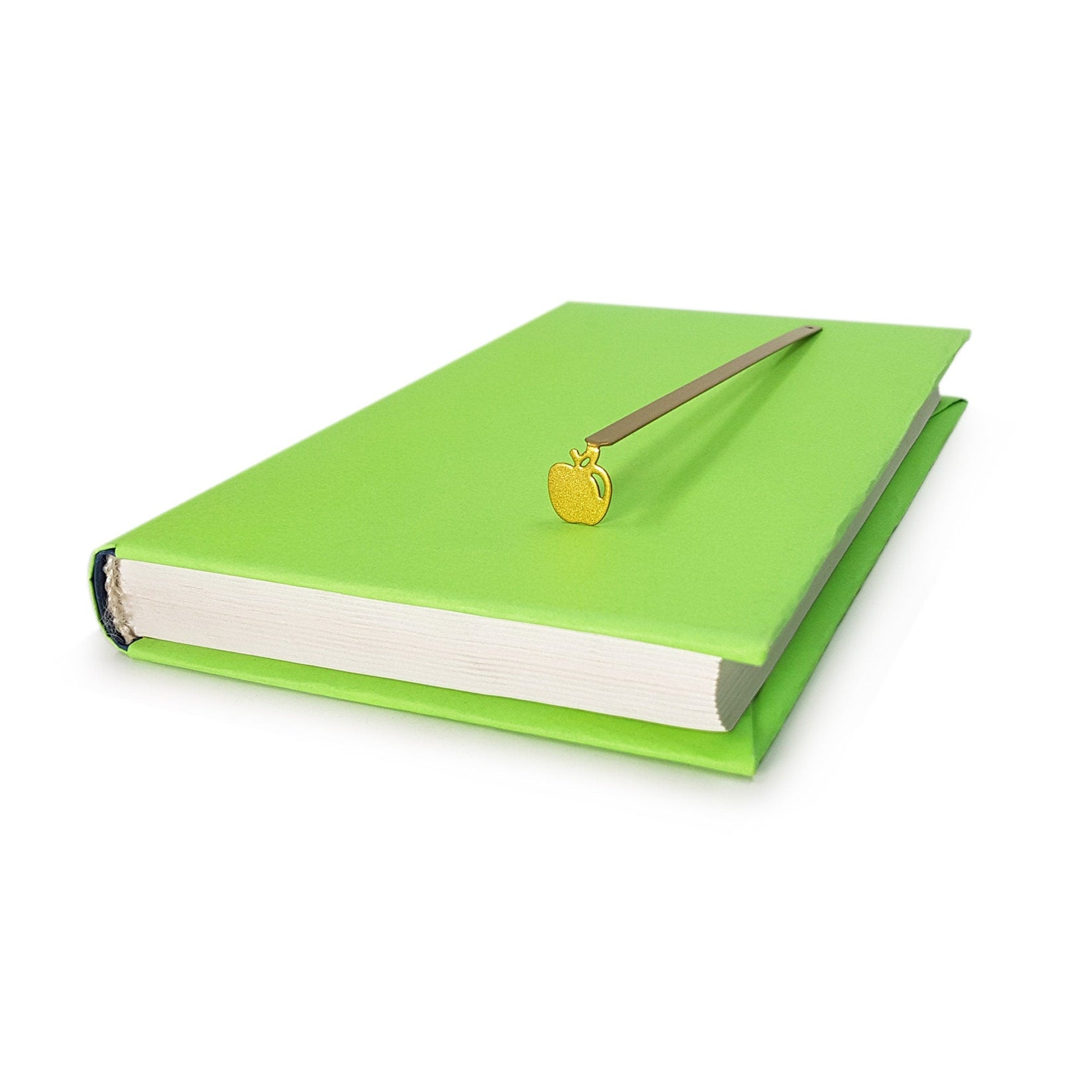Paradise Apple' metal bookmark in gold in a closed book, only its top showing above the pages